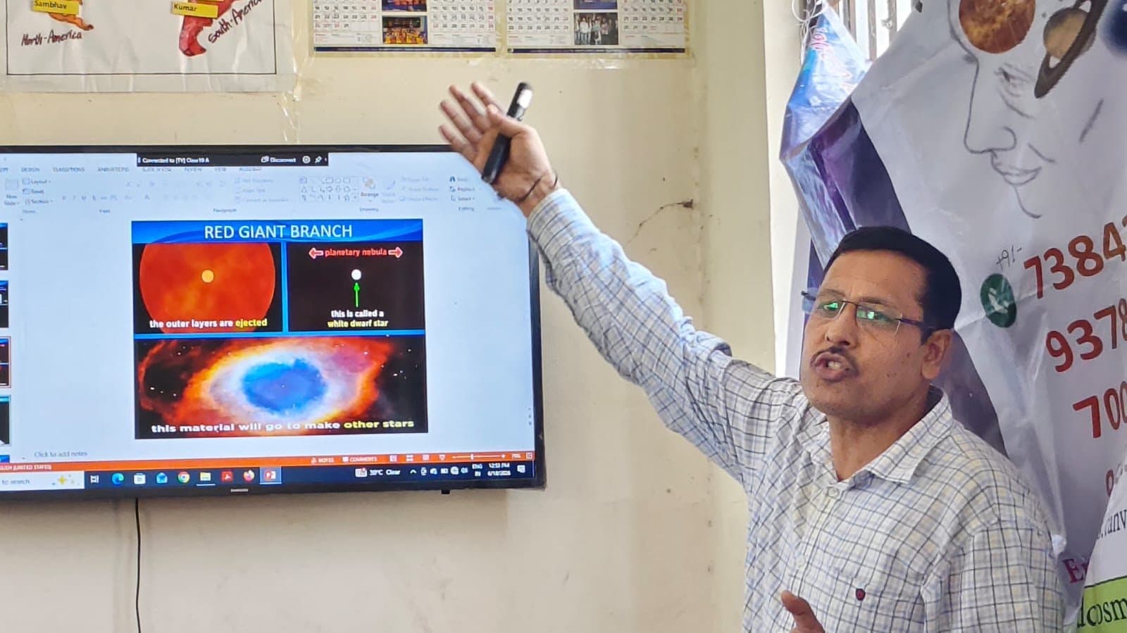A speaker gesturing towards a screen showing a diagram of the red giant branch of stellar evolution.
